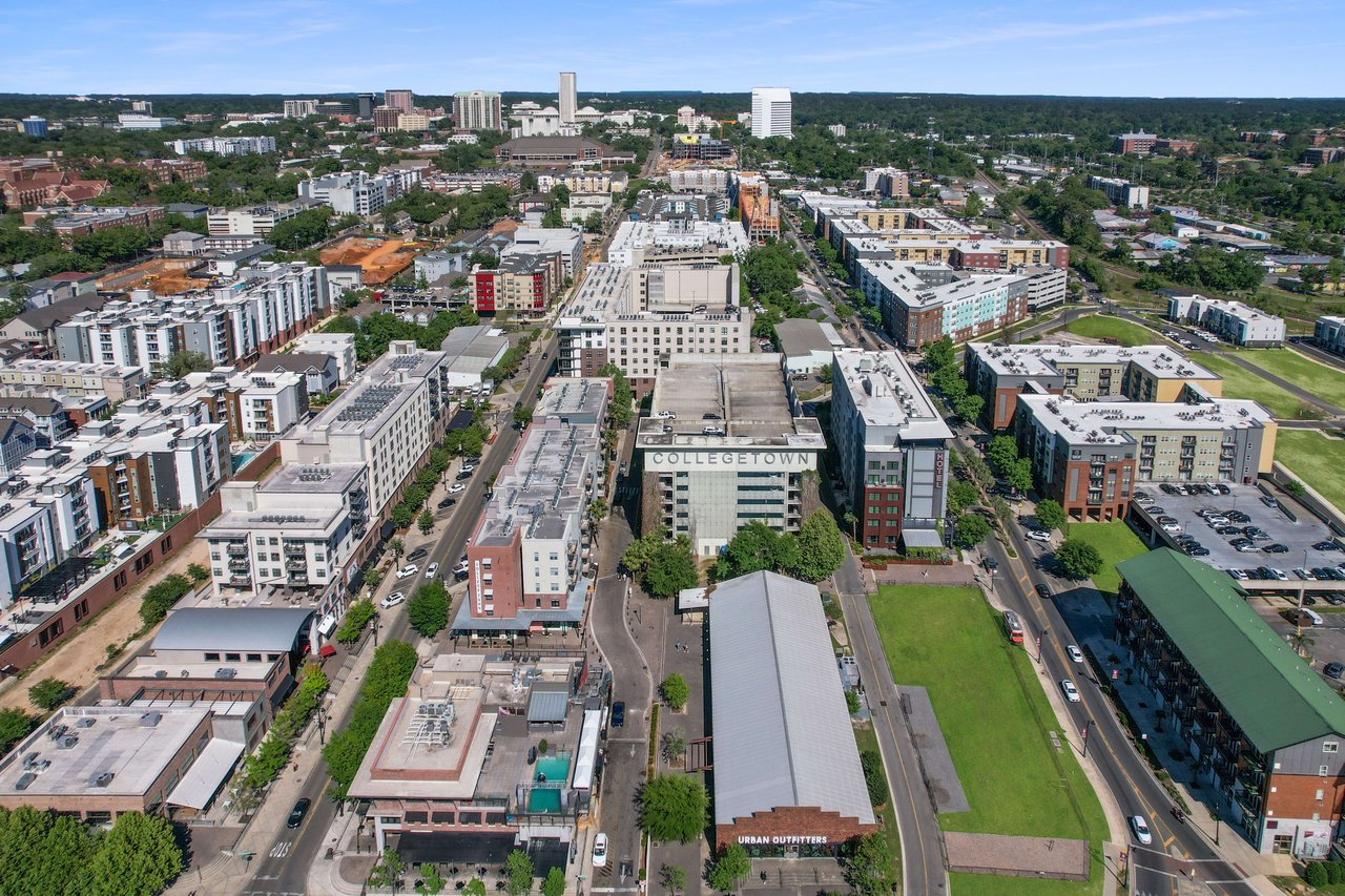 Another aerial view of College Town, focusing on the dense layout of buildings and streets within the urban area.