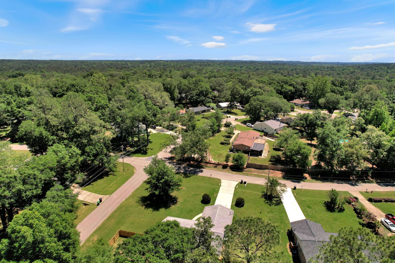 An aerial view of a residential area within the Killearn Acres community, showing houses and tree-lined streets.