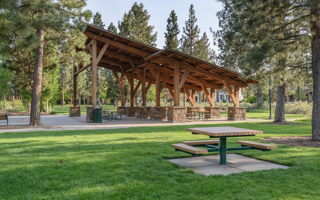 a picnic area surrounded by green grass and trees