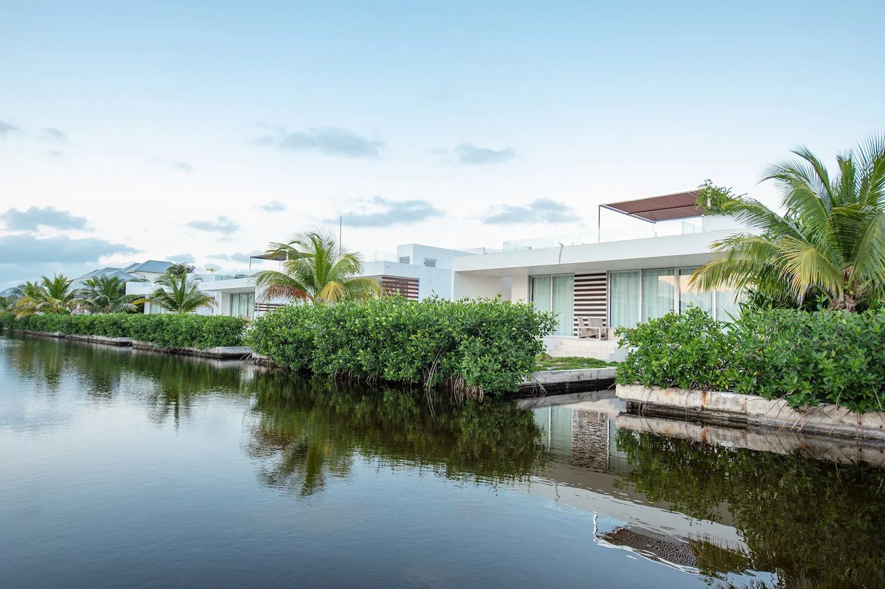 Unique tropical waterfront 3 bed 3 bath villa with a pergola and plunge pool on the rooftop terrace and with boat slip in a gated community on Ambergris Caye, Belize. 