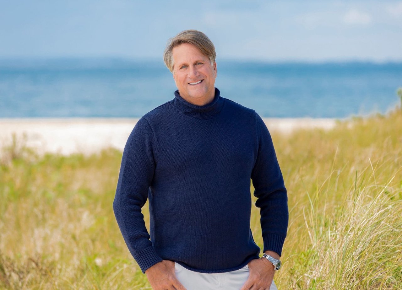 Scott Bradley, a licensed real estate professional from The Bradley Team, wearing a blue sweater on the beach.