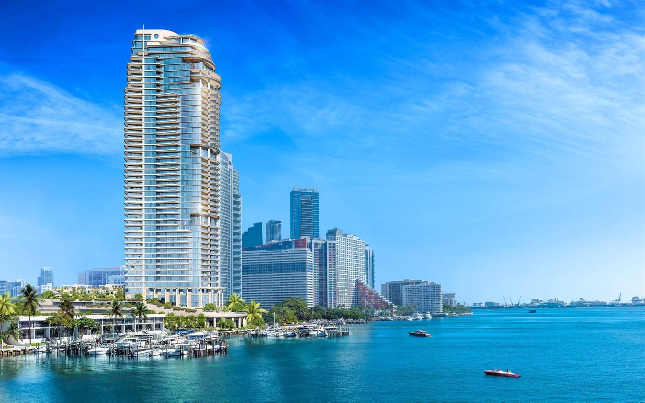 St. Regis Miami Residences tower beside Biscayne Bay, with a marina and Miami skyline.