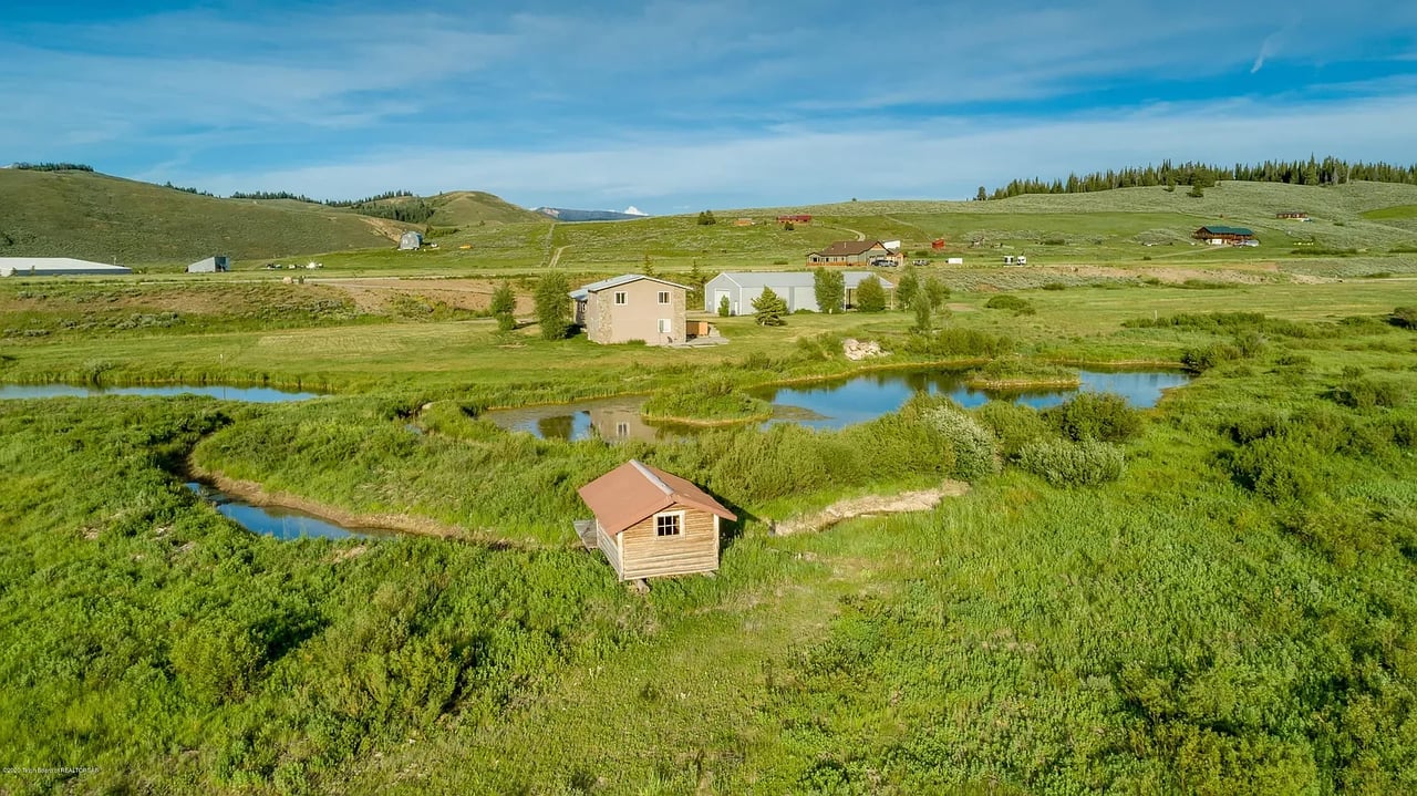 Home with shed cabin on river