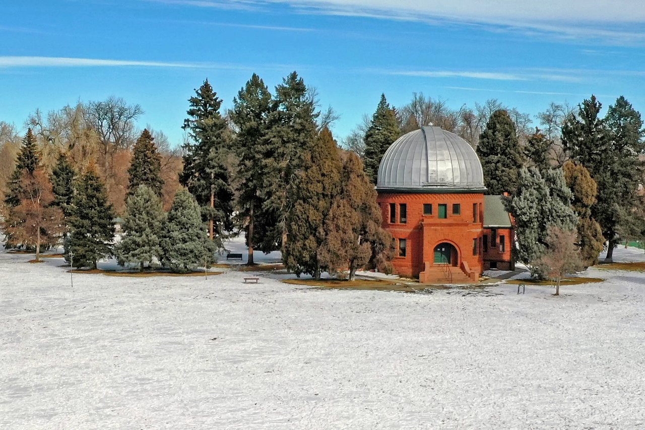 A red-domed brick building stands in a snowy field