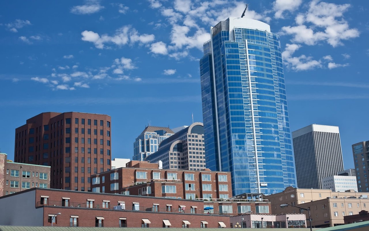 A bright, sunny day in Seattle, Washington, showcasing a mix of modern and older buildings.
