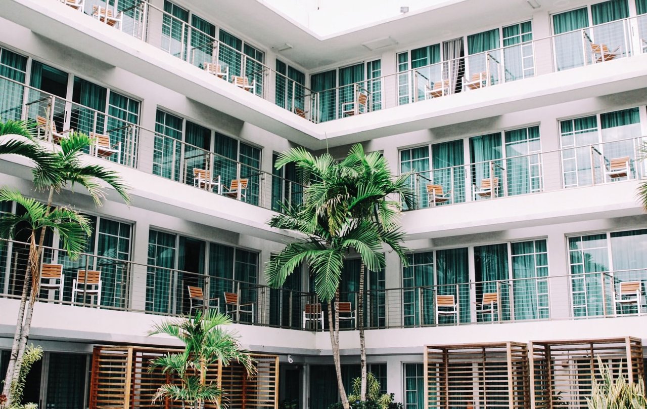  A medium, eye-level shot captures the interior courtyard of a modern, multi-story building, likely a hotel or apartment complex. 