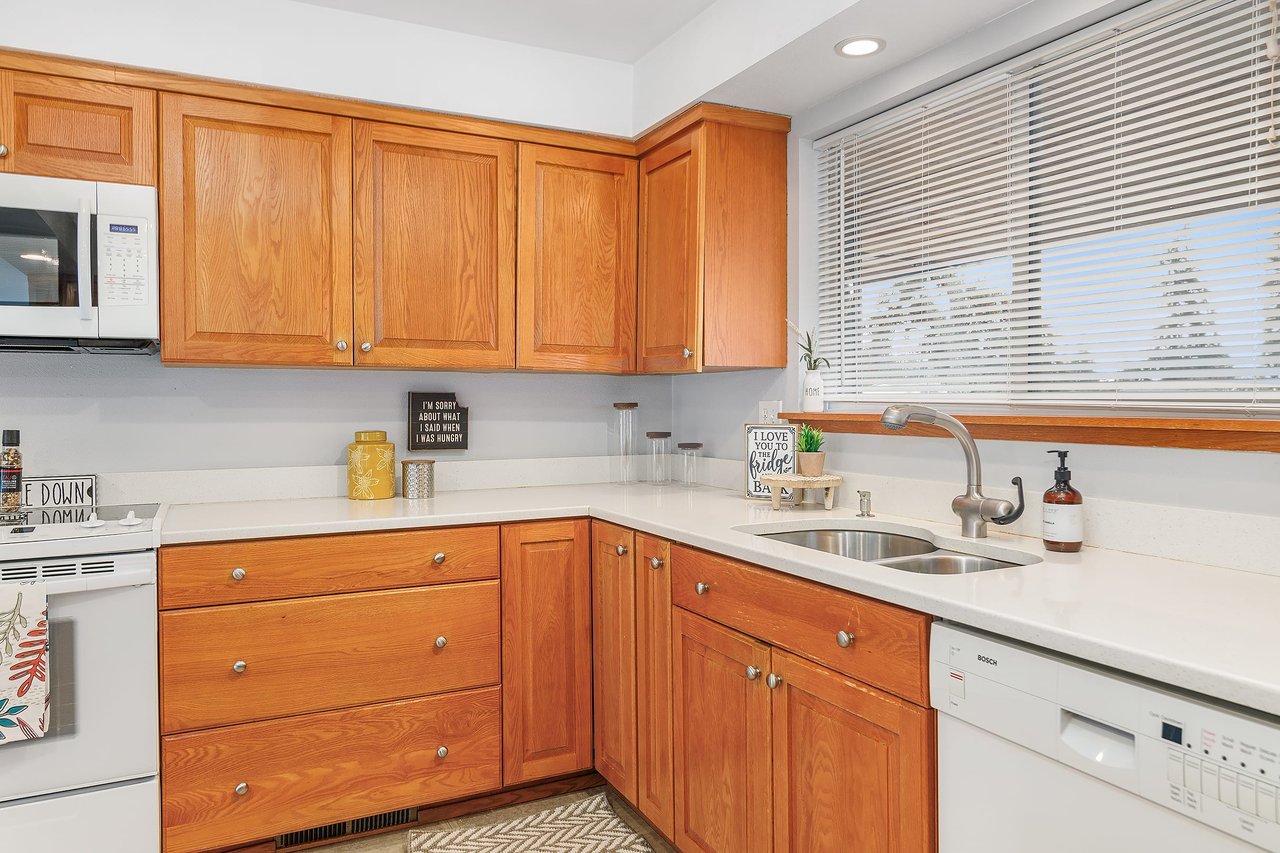 Let natural light shine in as you work with a window over the sink, creating a bright and airy atmosphere in this kitchen space.