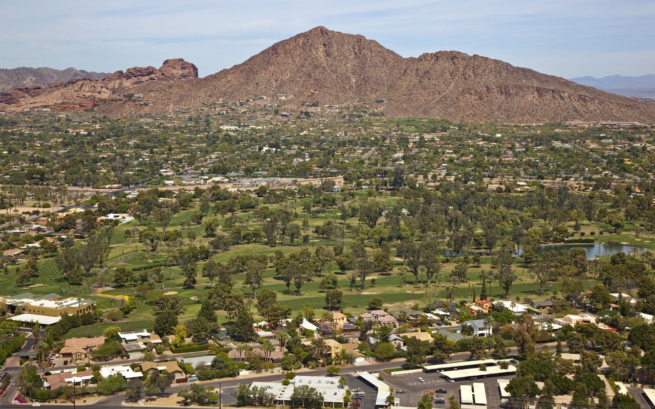 An aerial view of a city surrounded by mountains