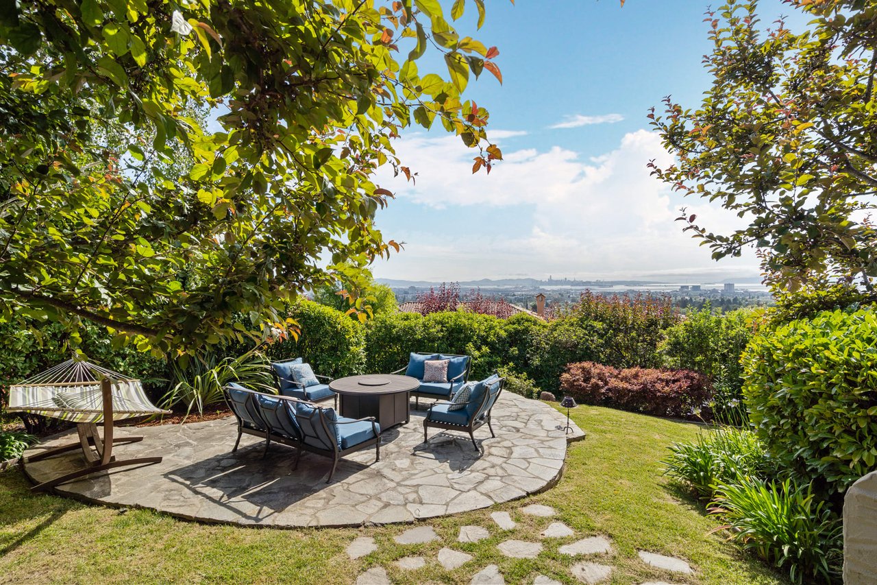 Backyard with table, chairs, umbrella, and hammock