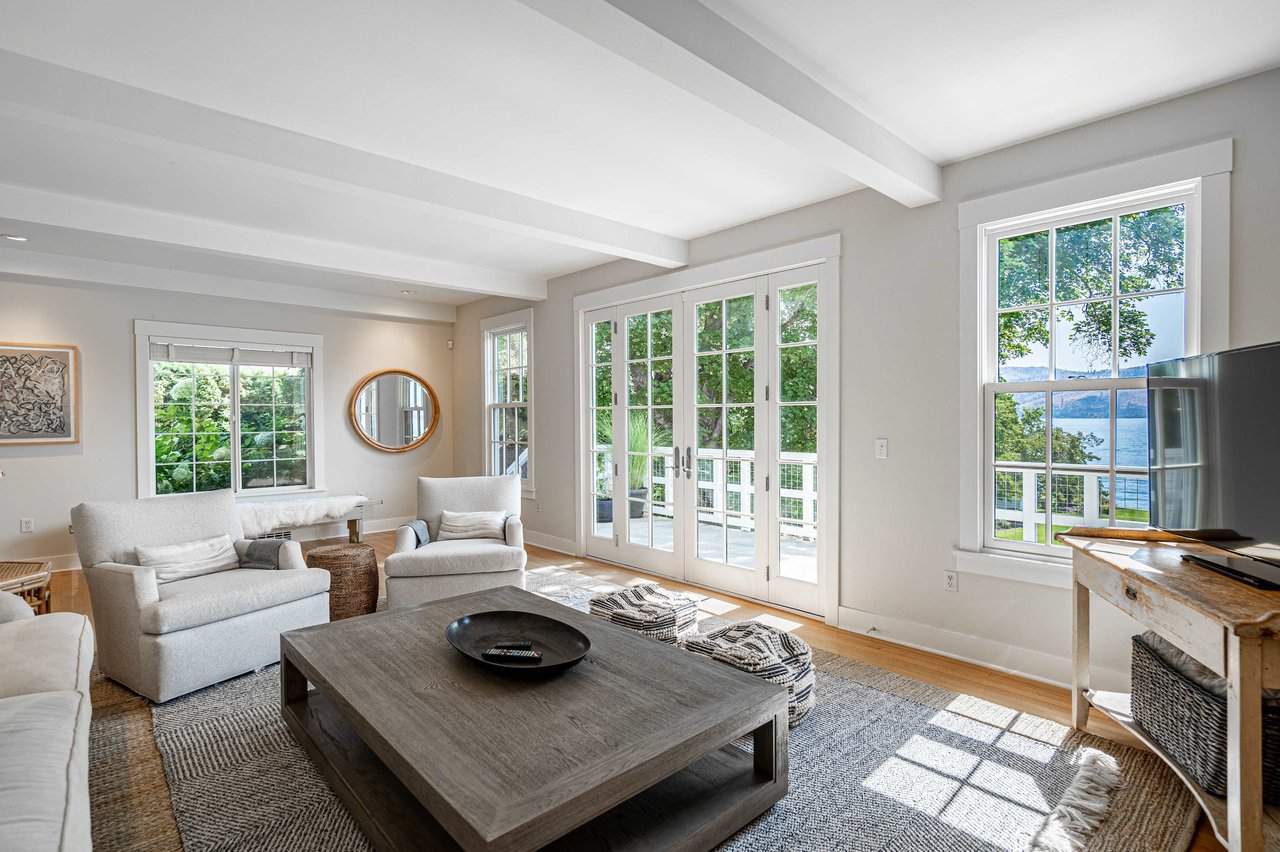 A bright and inviting living room with light-colored walls and wood flooring.