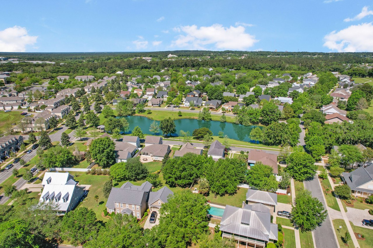 An aerial view of Southwood focusing on a residential area with a pond and several houses.