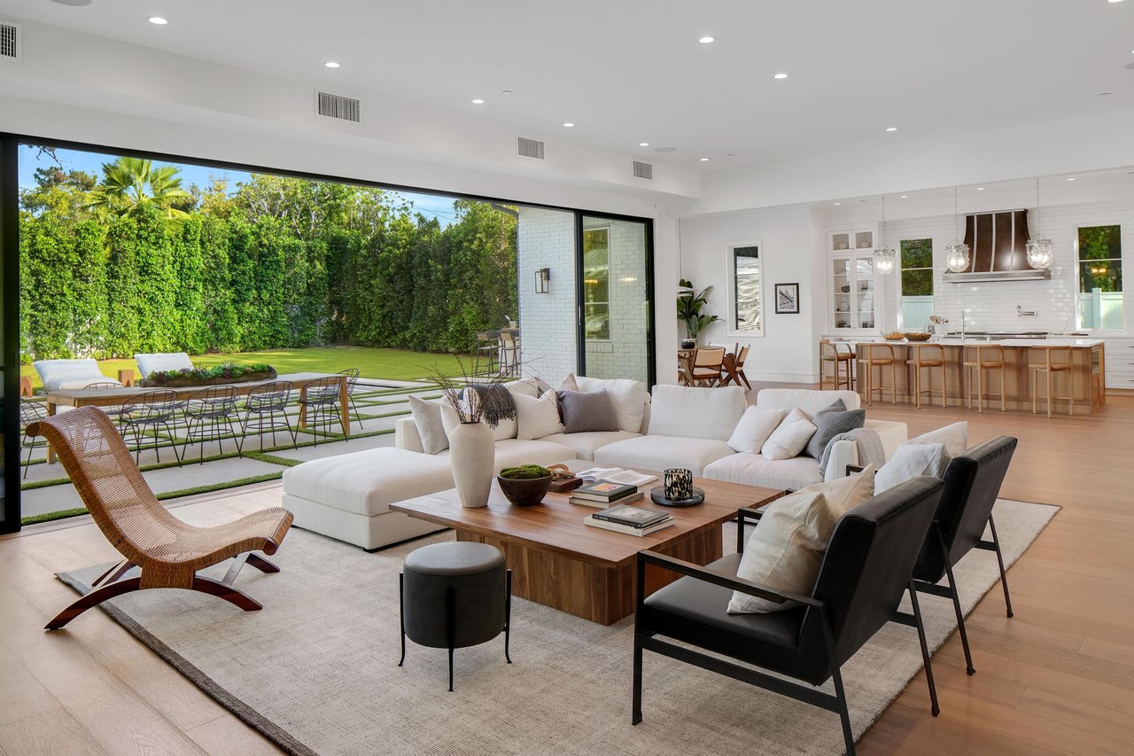 A luxurious, expansive open-concept living space seamlessly blends indoor and outdoor areas. 