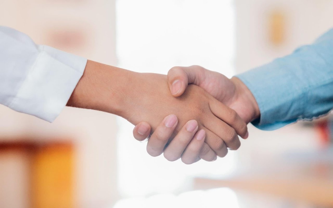  A close-up of two hands in a handshake