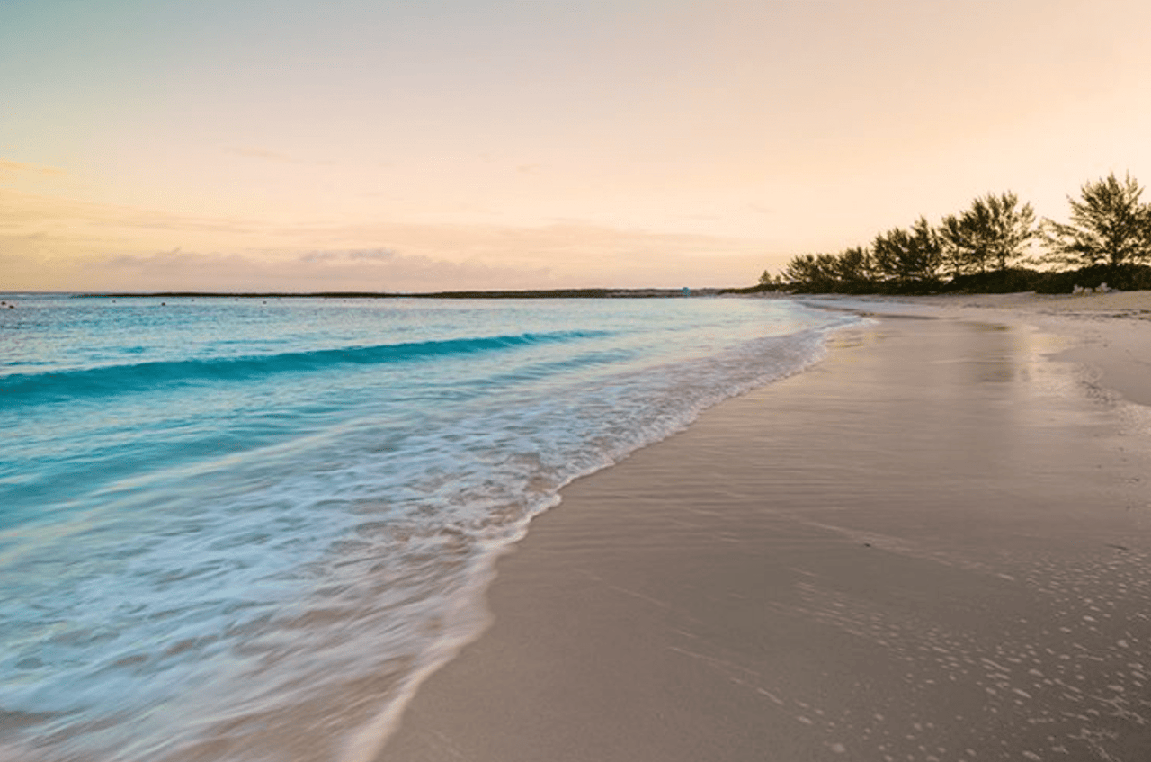 Beach shore with turquoise water in a sunset setting