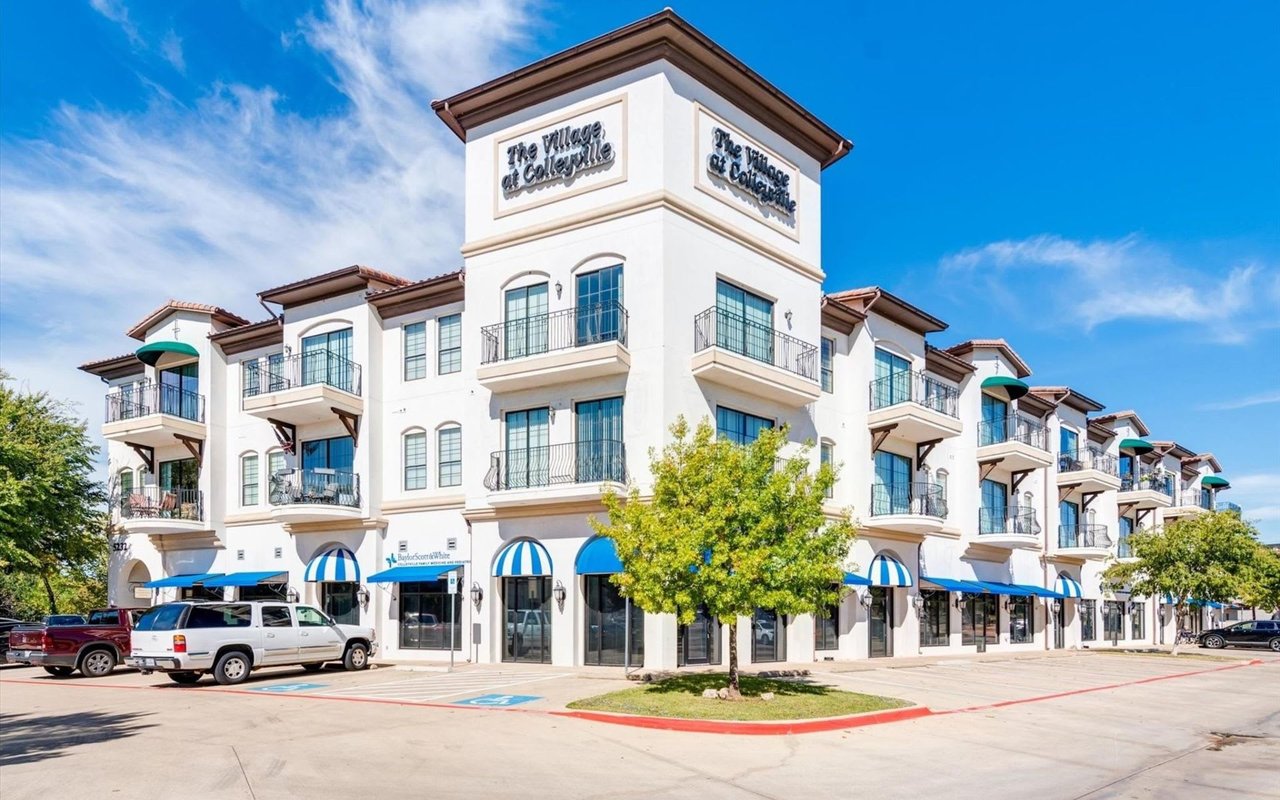 Modern, three-story apartment of The Village at Colleyville, with balconies, various amenities, and front parking lots.