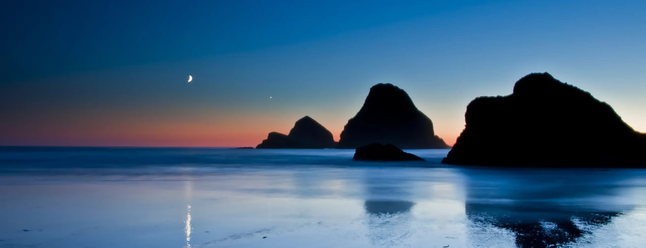 Evening sunset view with the moon on the horizon in Oceanside Oregon