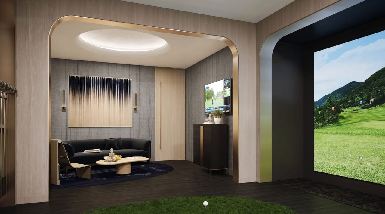 Golf simulator room with a lounge area, large course screen, and artificial turf.