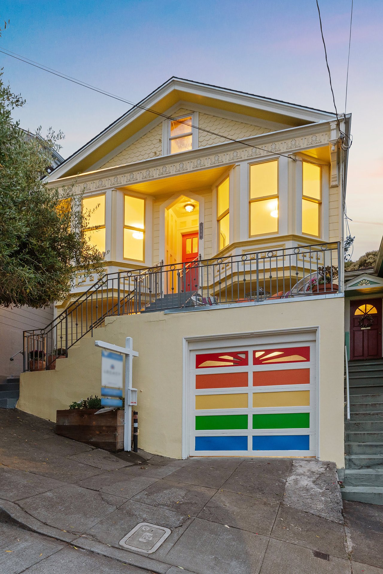 Bernal Heights Victorian home with for sale sign and rainbow colored garage