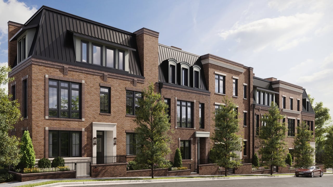 Modern brick facade with industrial accents at Tennyson Germantown, featuring large windows, lush greenery, and rooftop terrace views.