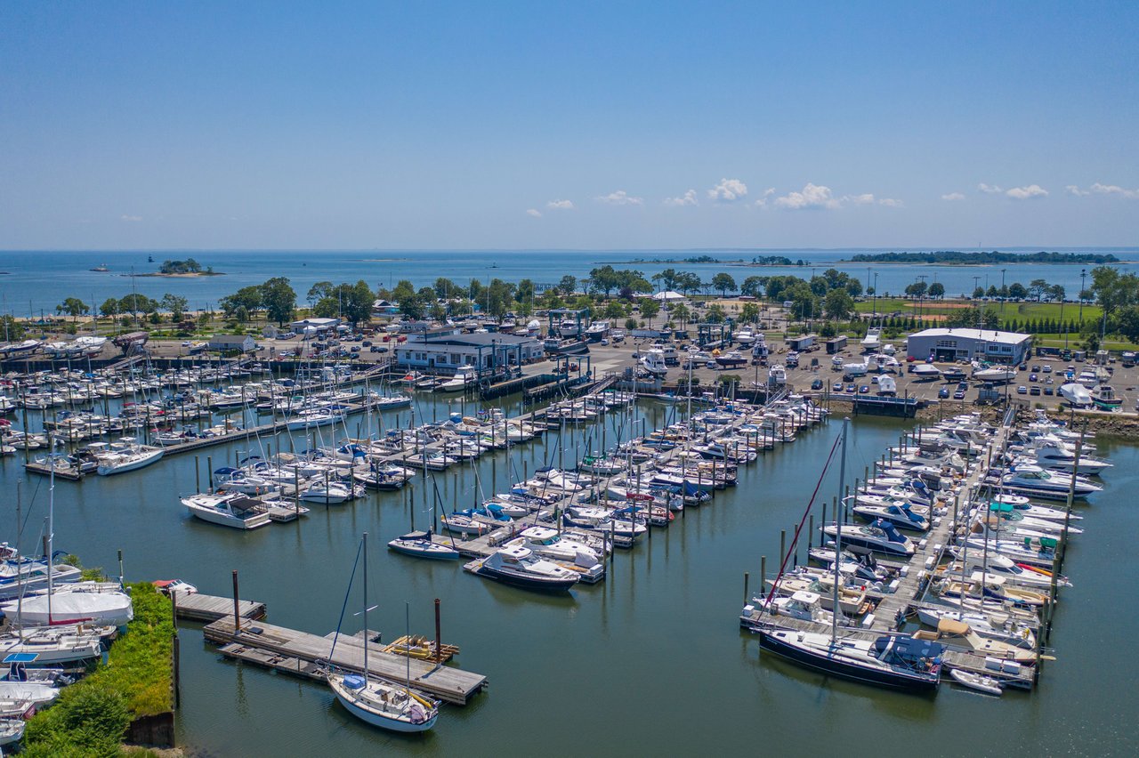 A marina filled with boats of all shapes and sizes docked neatly in rows.