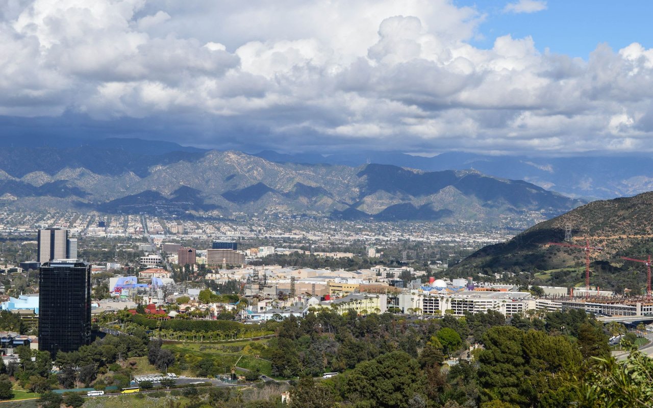 A view of a cityscape with mountains in the background.