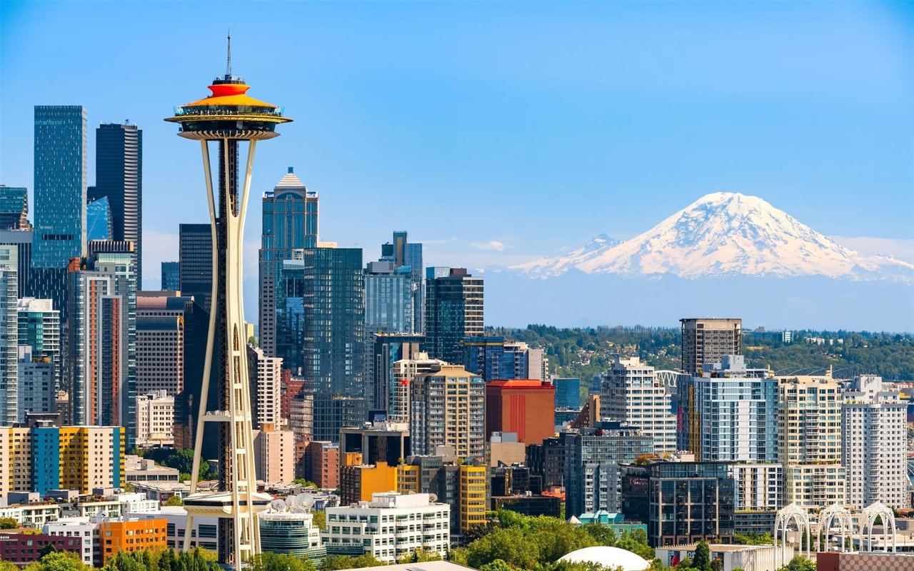 Seattle skyline featuring the Space Needle with Mount Rainier in the background.