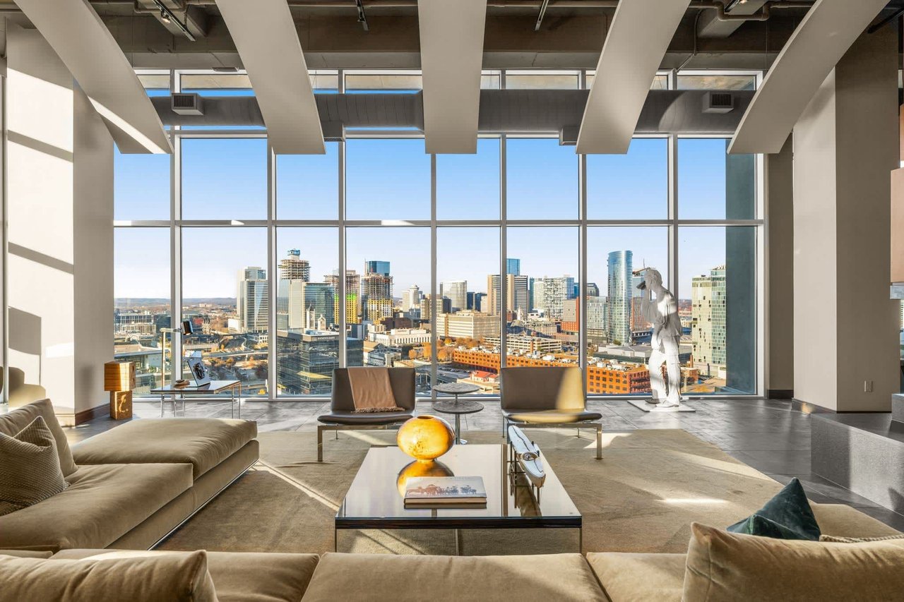 Spacious Icon in the Gulch penthouse living room with floor-to-ceiling windows and Nashville skyline views