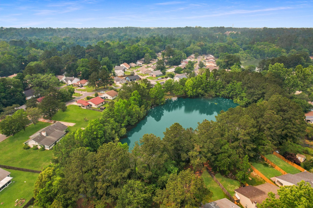 Another aerial view of Hartsfield Village, emphasizing the layout of houses, streets, and the surrounding greenery.