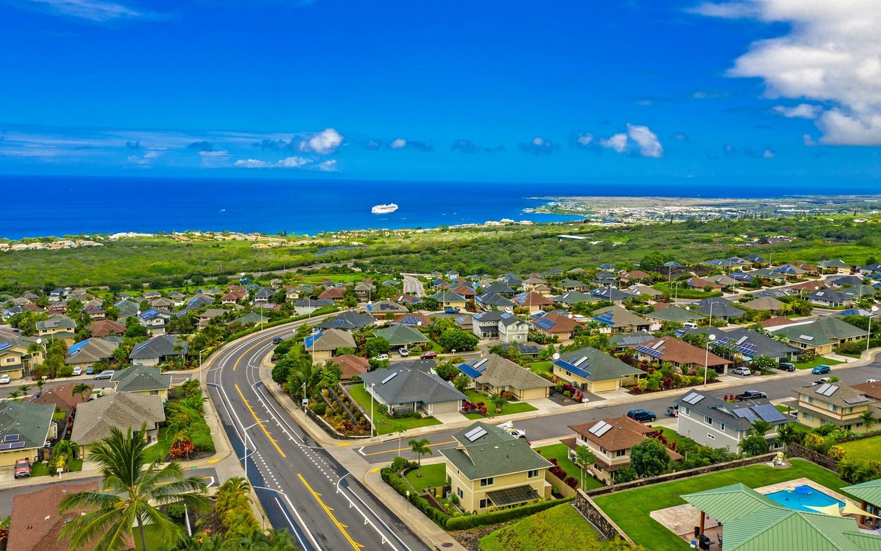 An aerial view of the coastal neighborhood in Iolani Hawaii, with a cruise ship in the background