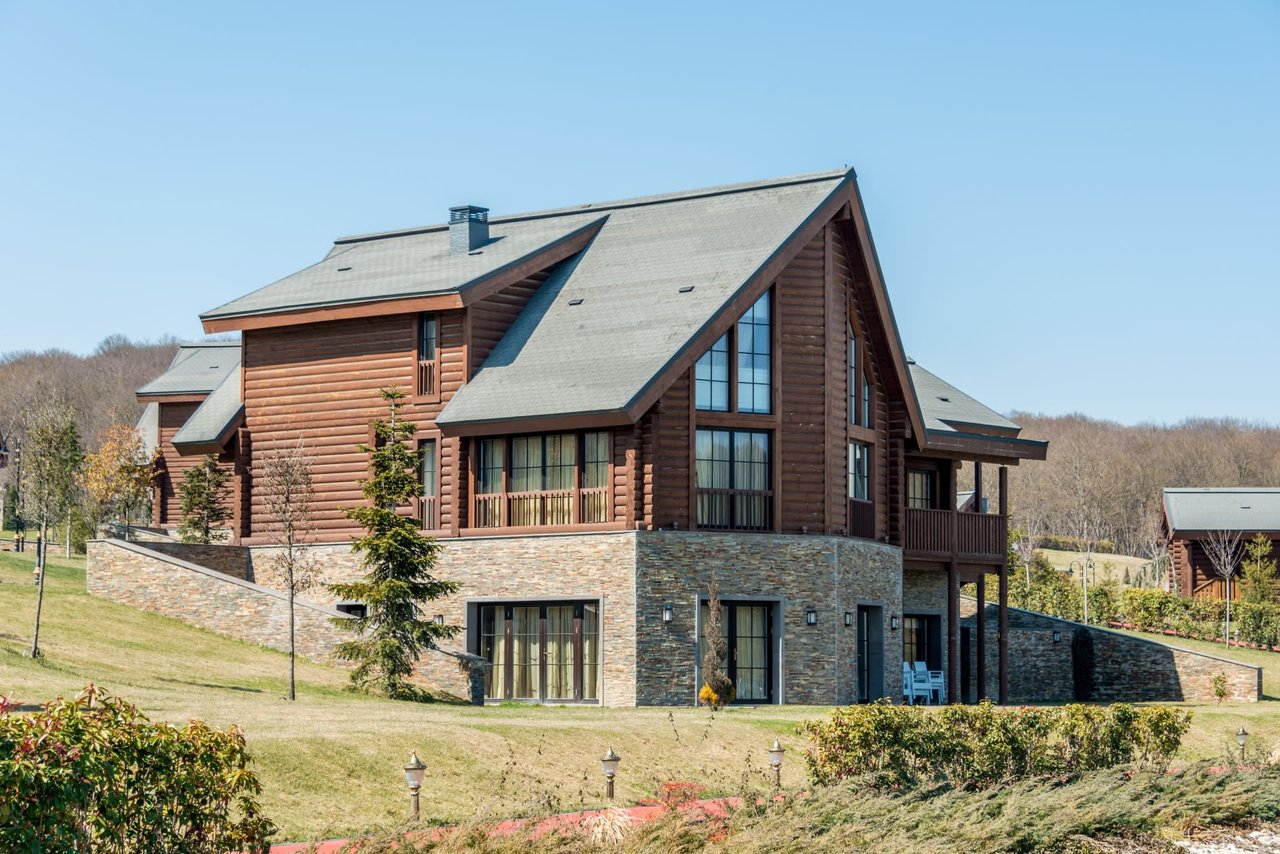 large, upscale A-frame log cabin with a stone lower level in Rye, CO