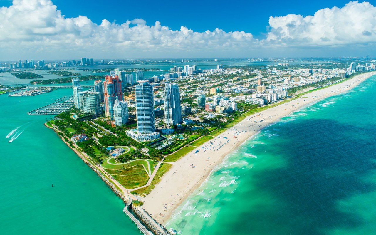  A dense urban landscape of tall buildings and smaller structures fills the land, with some green spaces visible.