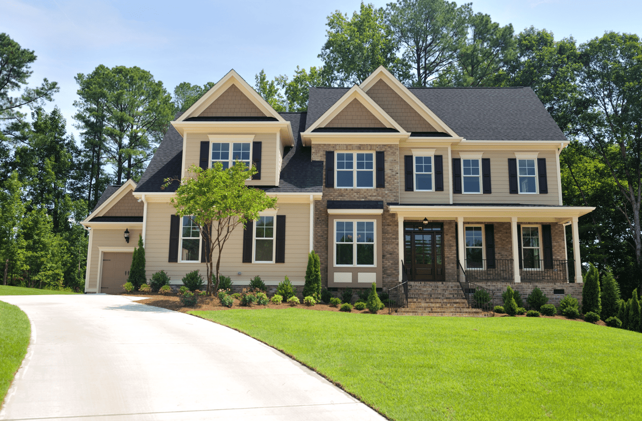 A large two-story colonial house with a symmetrical facade, double-hung windows, and a gray Fairfield Style Crest vinyl siding exterior.