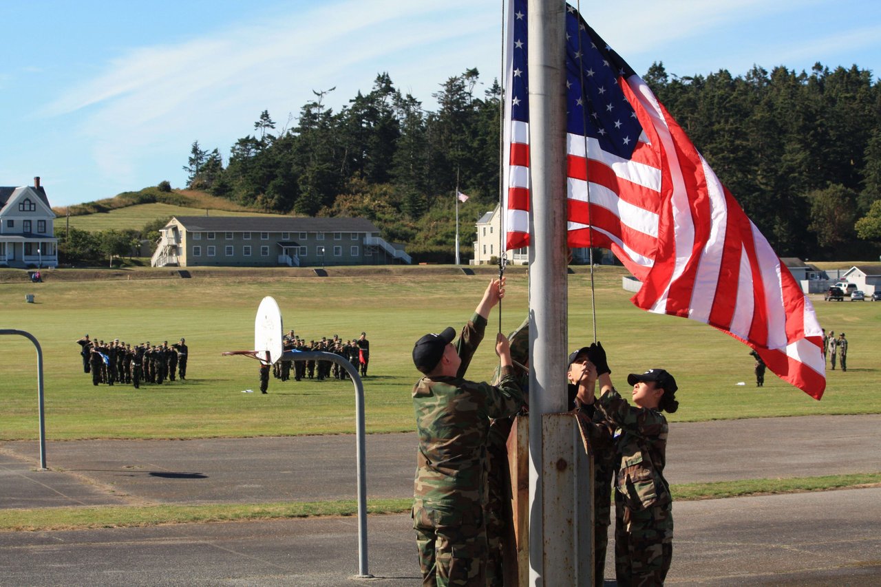 military men raising the american flag