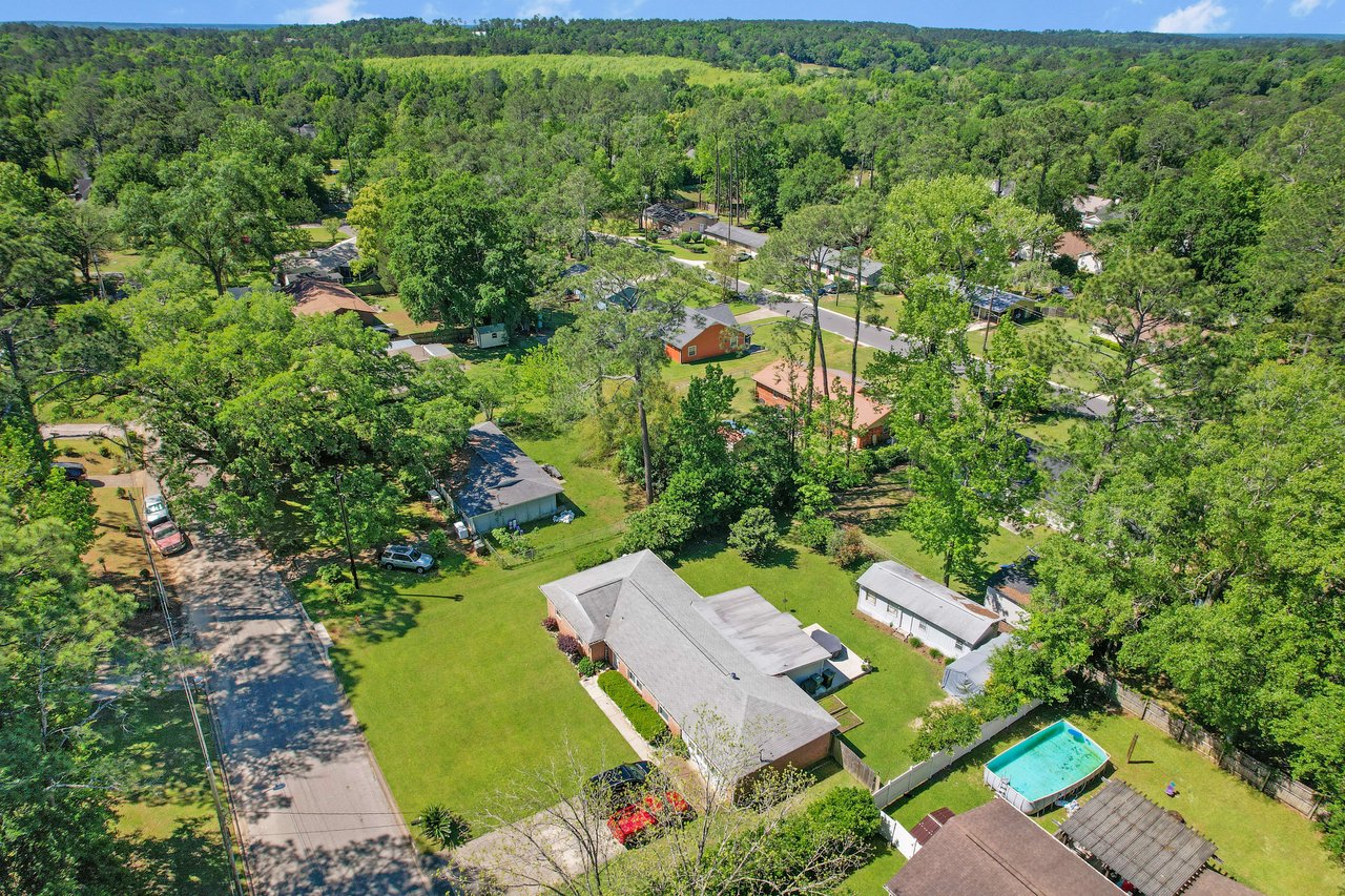 Aerial view of a residential neighborhood in the Old St. Augustine with houses and significant greenery.