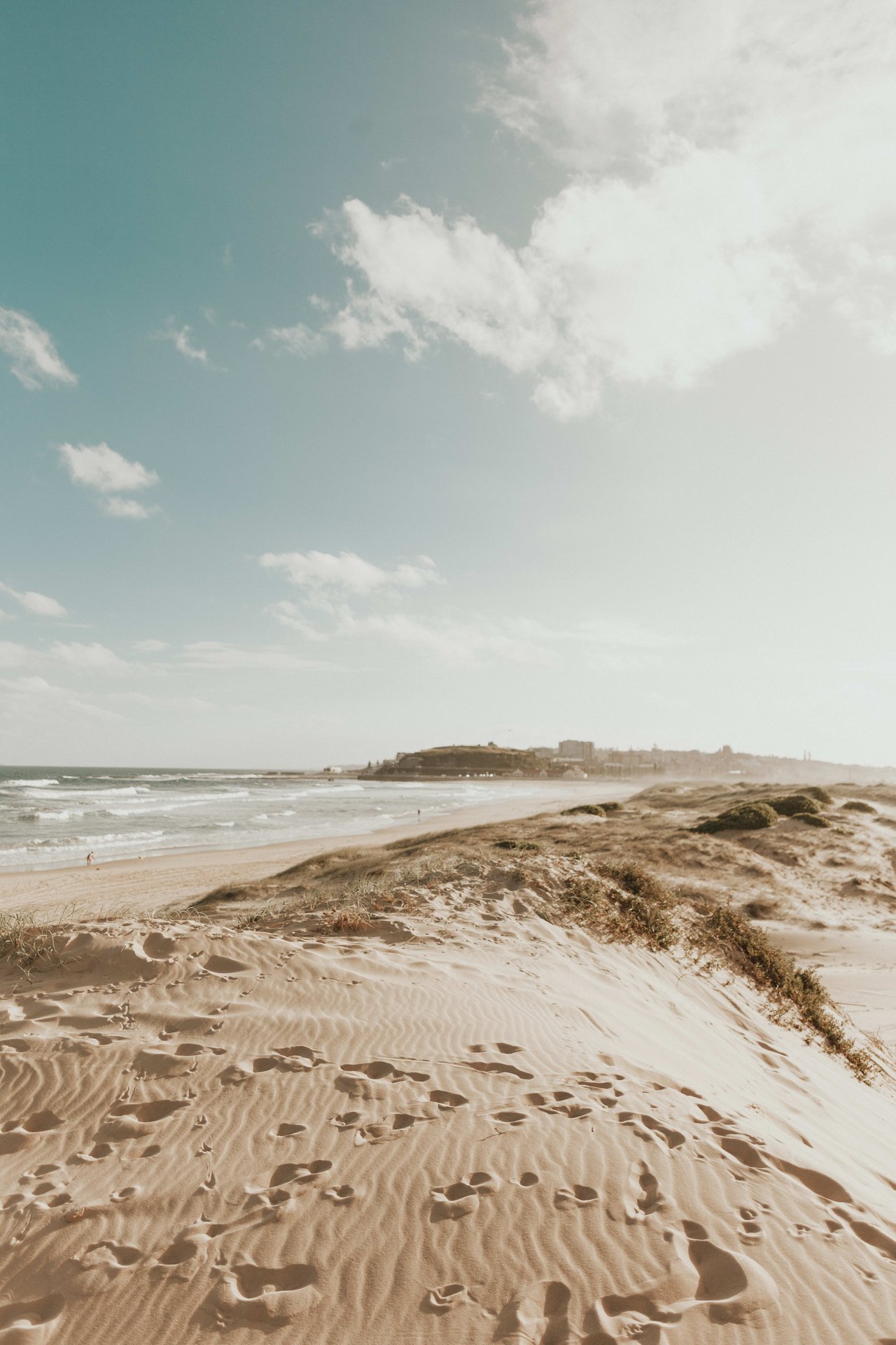  A serene beach scene on a slightly overcast day. 
