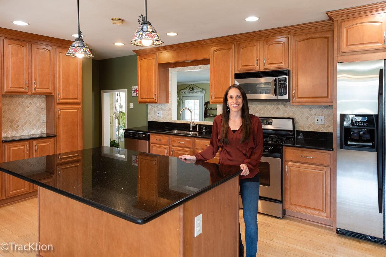 Sabrina Glover showing the open kitchen inside her newest Downers Grove listing