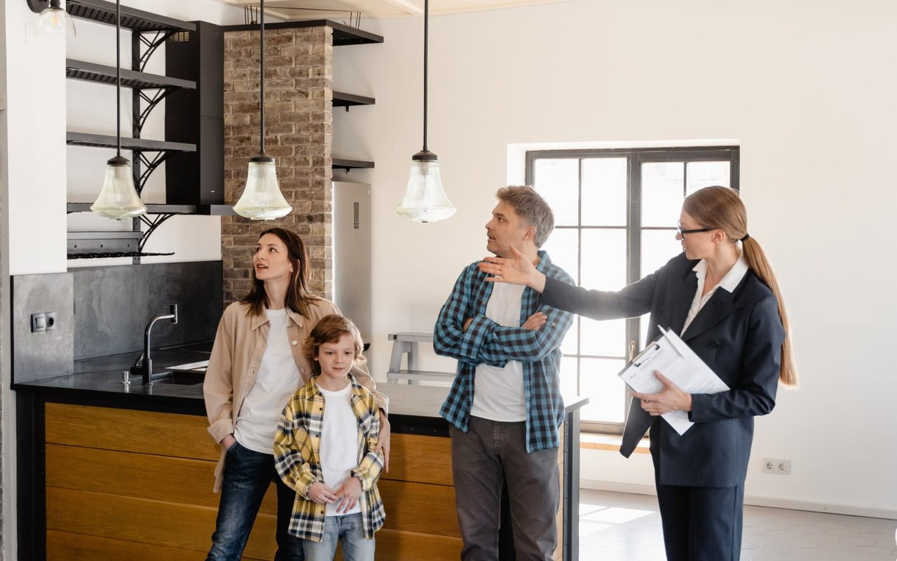 A real estate agent showcasing a residential property to a family.