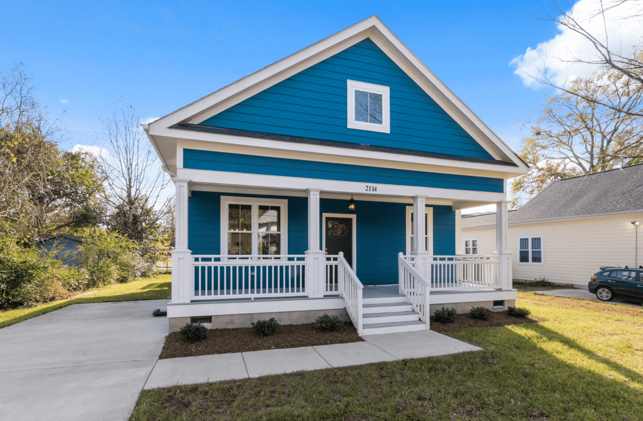 A blue and white house with a covered porch.