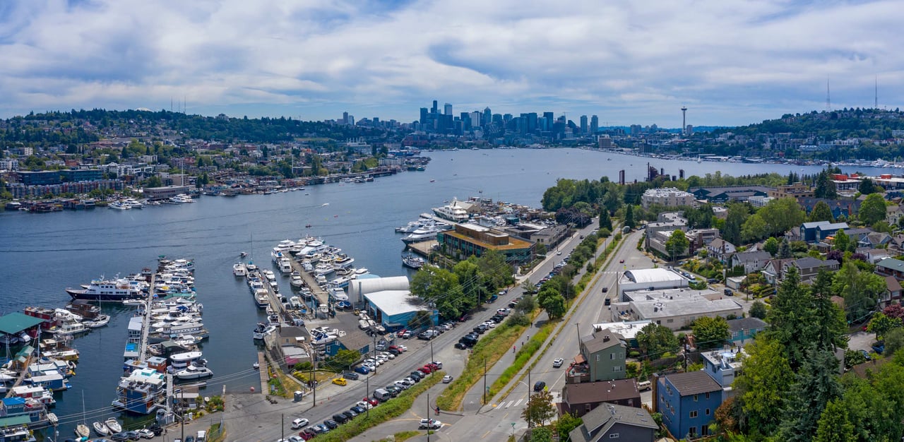 The lake is filled with numerous boats and surrounded by marinas and residential areas.