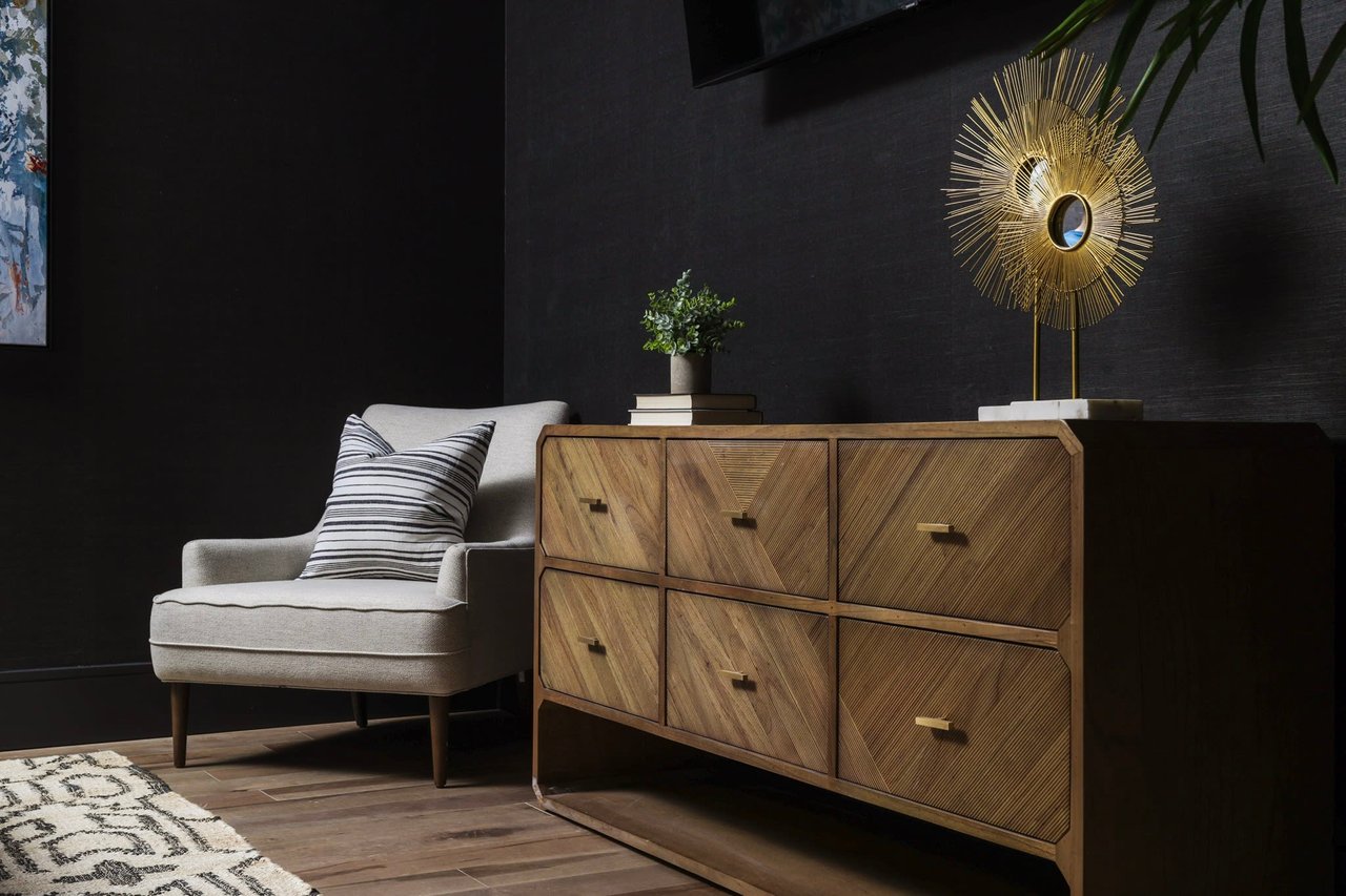 Elegant guest bedroom featuring a luxurious brown dresser rental from Elite Austin