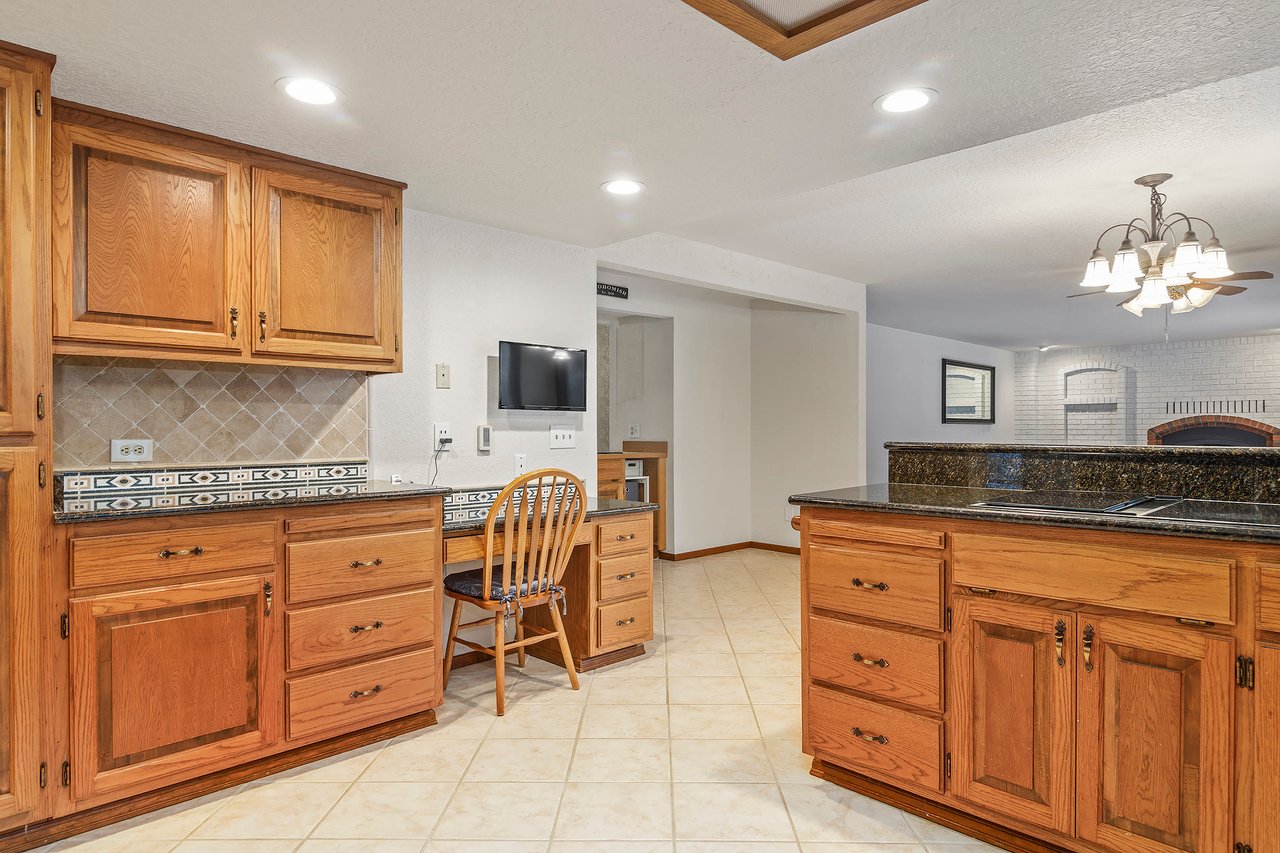 Explore the kitchen's abundance of cupboards, providing ample storage for all your culinary needs. Plus, there's a handy small desk, perfect for meal planning or catching up on work while keeping an eye on your culinary creations.