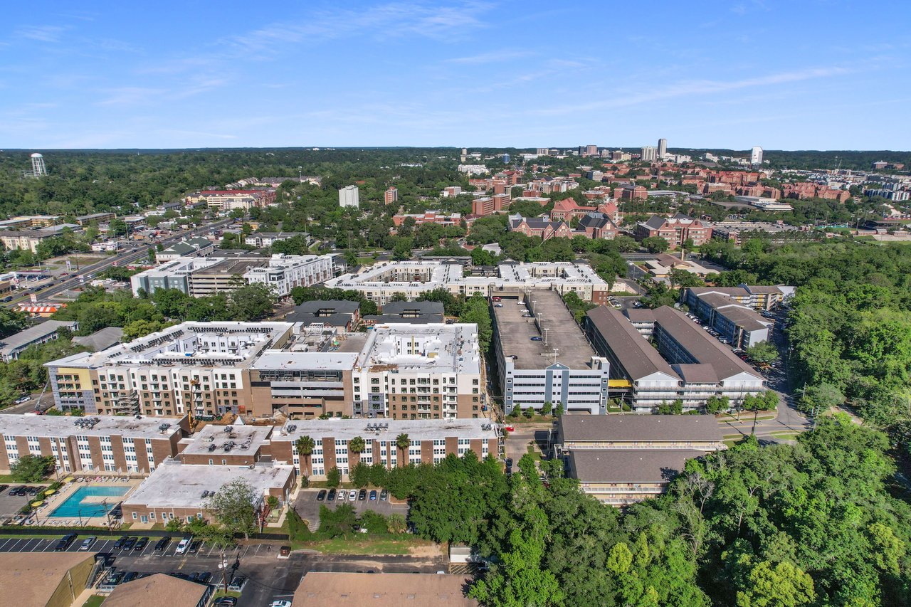 Another aerial view of Chapel Hill, highlighting a mix of residential and commercial buildings, streets, and green areas within the community.