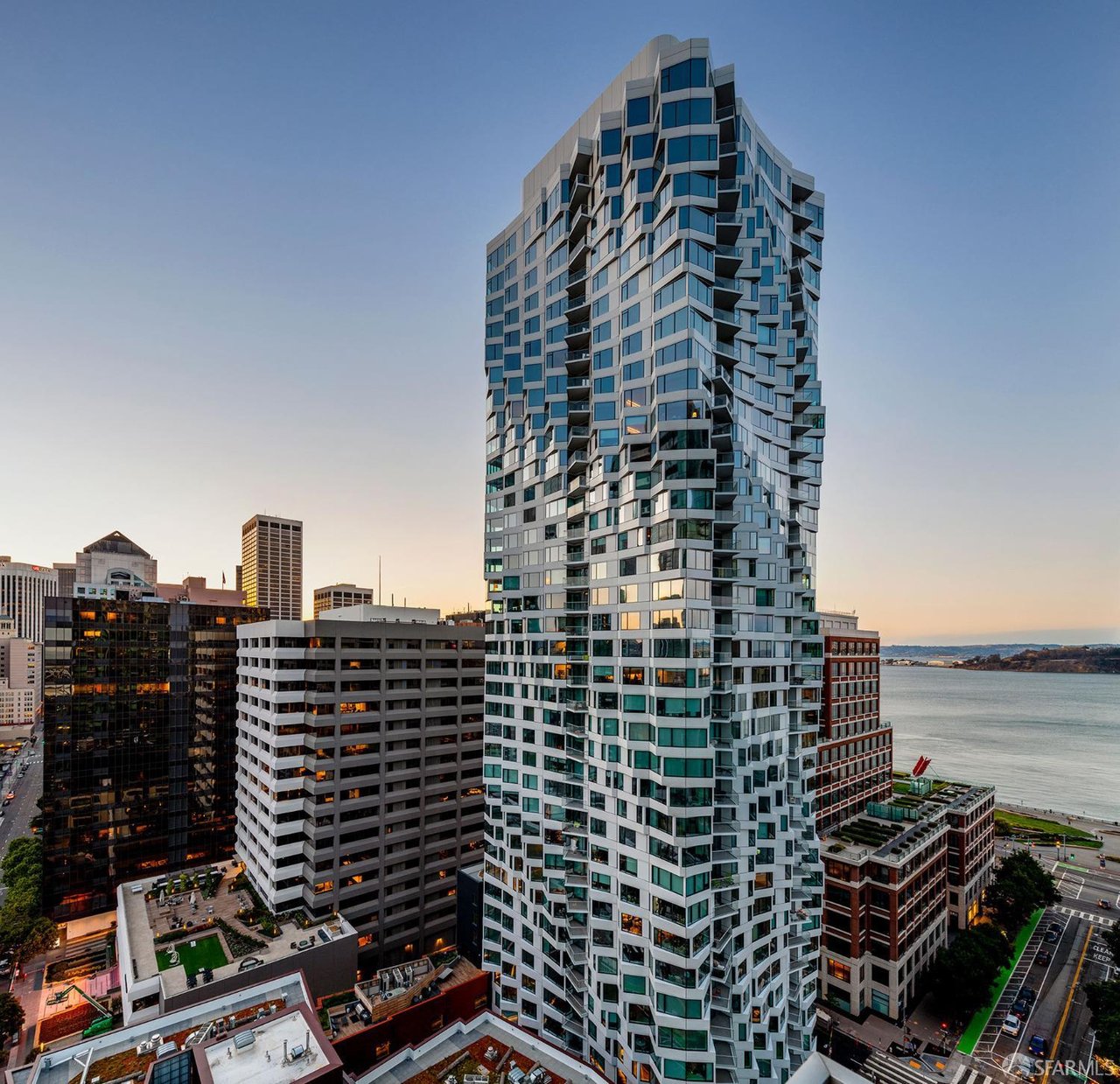 MIRA Tower, a distinctive residential skyscraper in San Francisco, surrounded by modern high-rise buildings in the city’s urban landscape.
