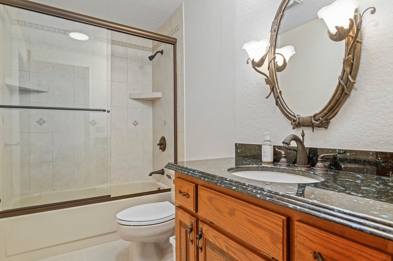 The bonus room features a convenient bath with a tiled tub, providing an added layer of comfort and style to this versatile space.