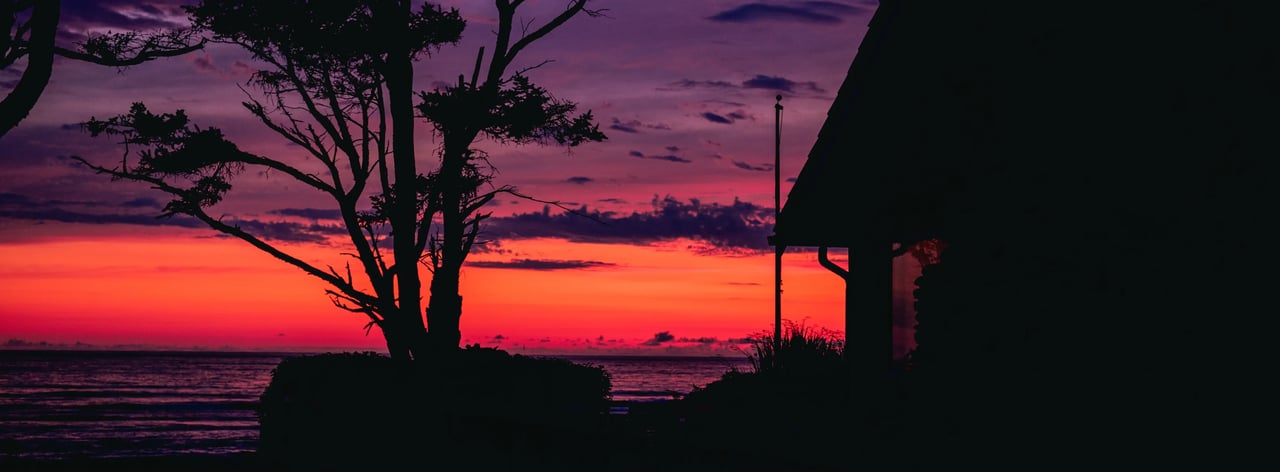 Bright pink and purple sunset from oceanfront home in Seaside Oregon