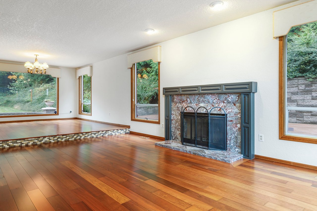 The formal living room boasts a stunning tiled fireplace, adding a touch of luxury and warmth to this already charming space.