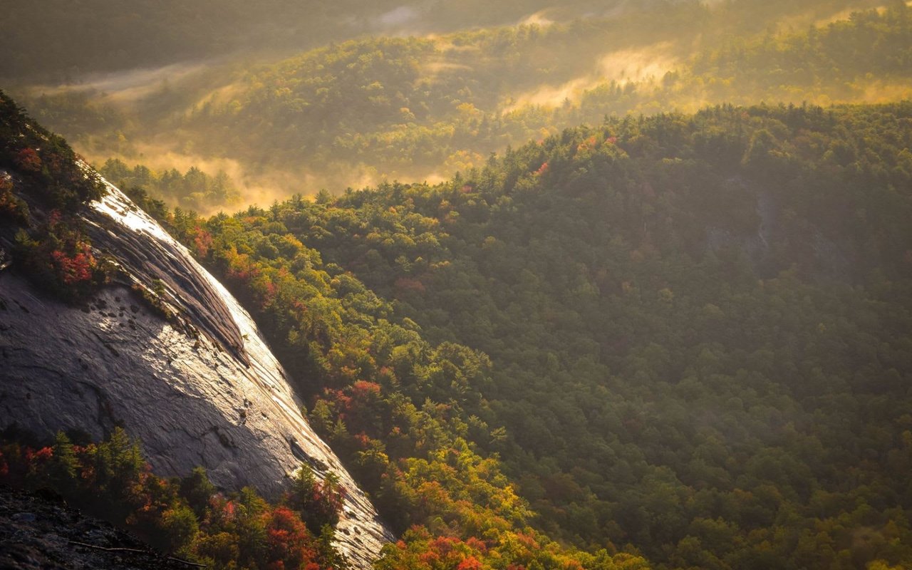 Sunset in Highlands north carolina with a huge rock face and miles of forests