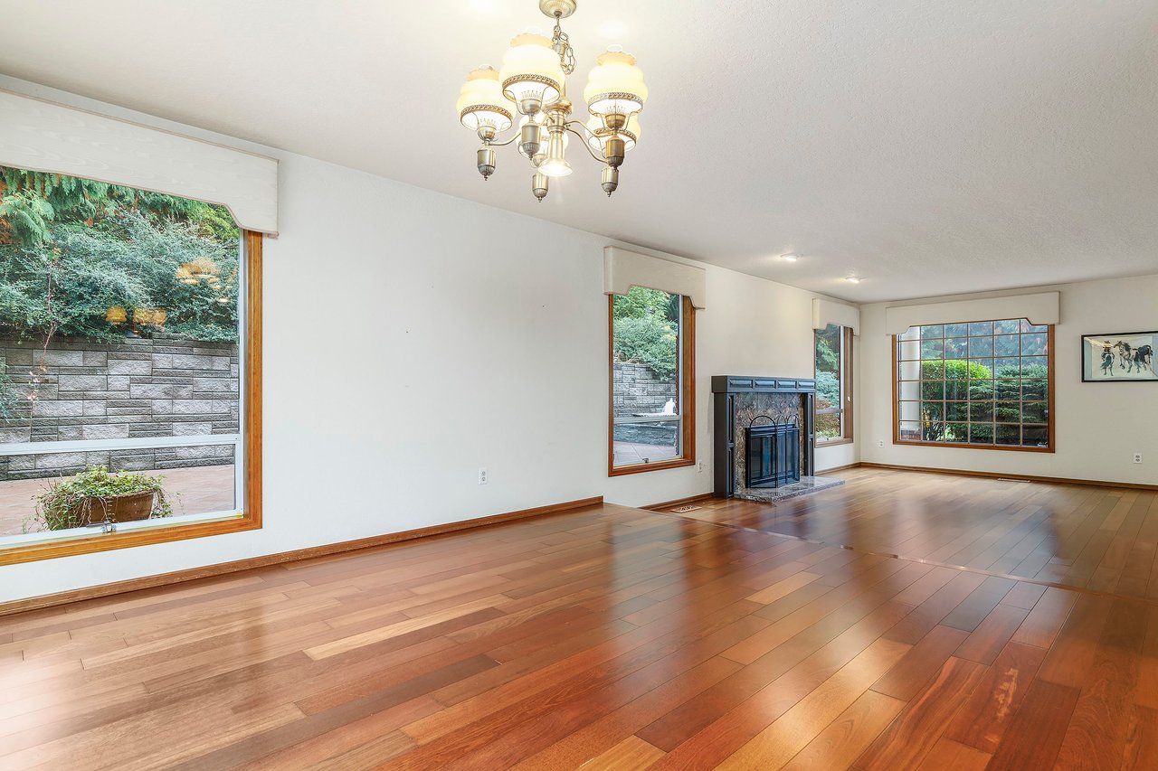 Experience the seamless flow of this home's layout as you move from the formal family room, with its inviting ambiance, to the elevated formal dining room.