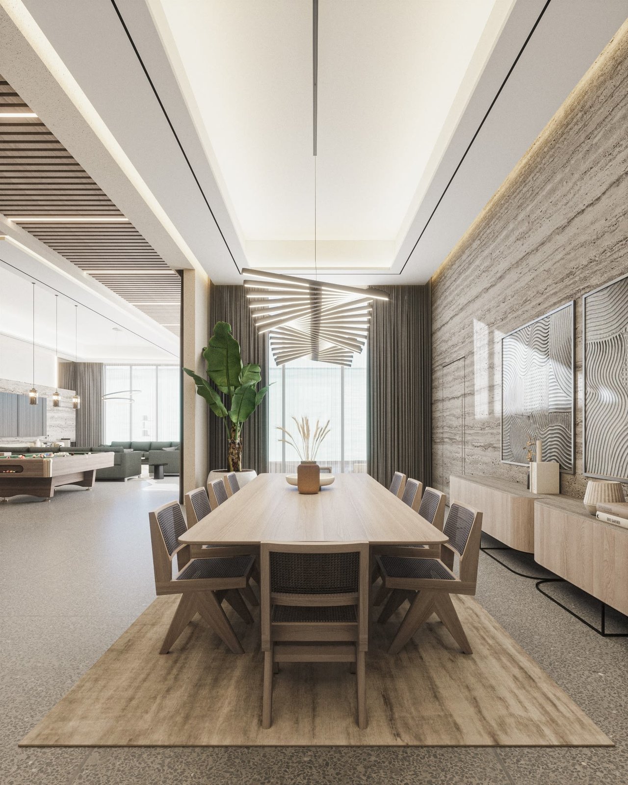 Modern dining room with a long wooden table, sculptural ceiling lights, and stone-textured walls.