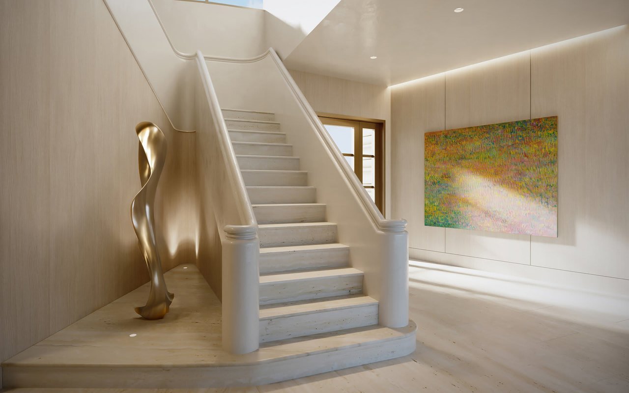 Staircase with curved stone balustrades, a gold-toned sculpture, and colorful abstract artwork.